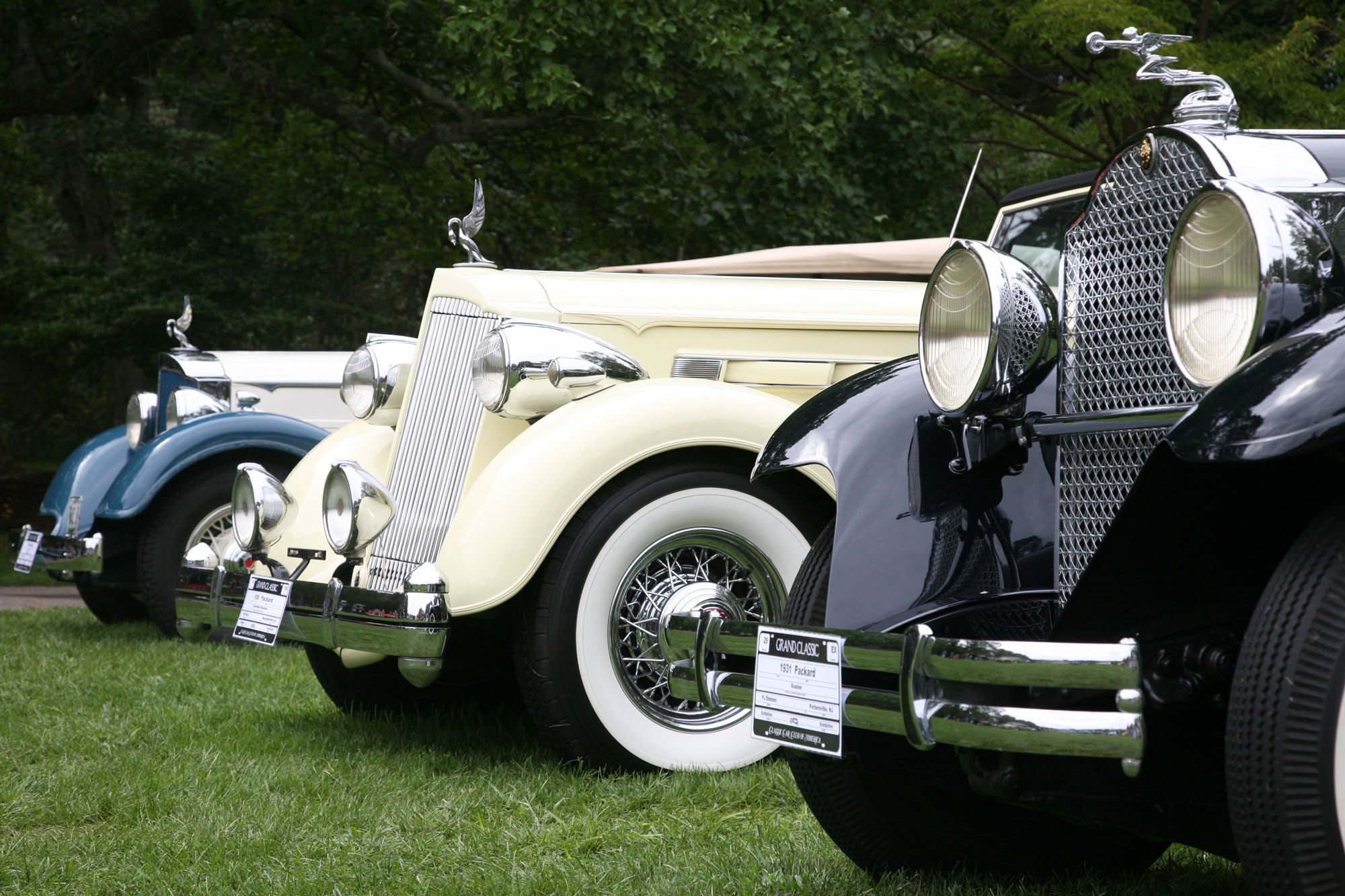 This is a photo of three classic cars insured through Stonewall Insurance Group
